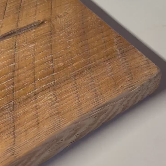 Close-up of a 3/4" solid ash wood board with a wire-brushed finish. Natural grain patterns and saw marks add a rustic farmhouse touch.