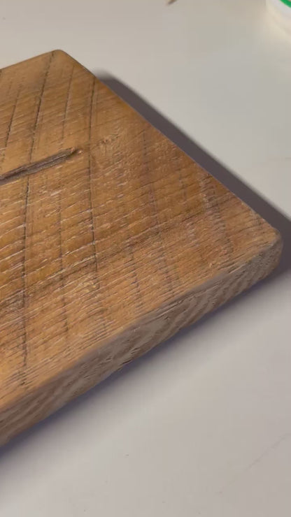 Close-up of a 3/4" solid ash wood board with a wire-brushed finish. Natural grain patterns and saw marks add a rustic farmhouse touch.